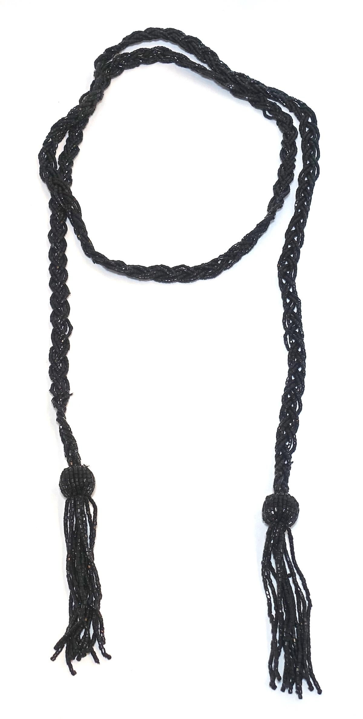 This vintage art deco 1920ss necklace features a torsade design with black beading.  This piece measures 54” long x 1/2” and is in excellent condition.