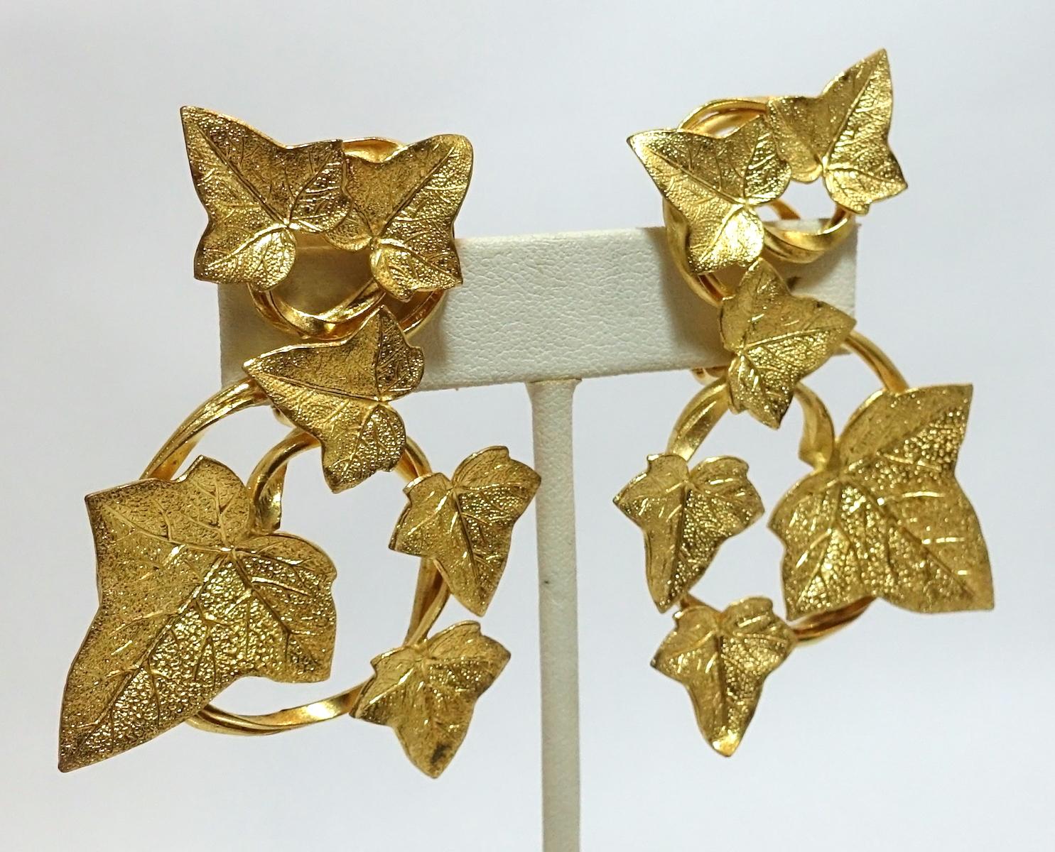 These vintage signed Dominique Aurientis Paris earrings feature a heavily etched floral design in a gold tone setting.  These clip earrings measure 2-1/2” x 1-3/4” and are signed “Dominique Aurientis Paris”. They are in excellent condition.