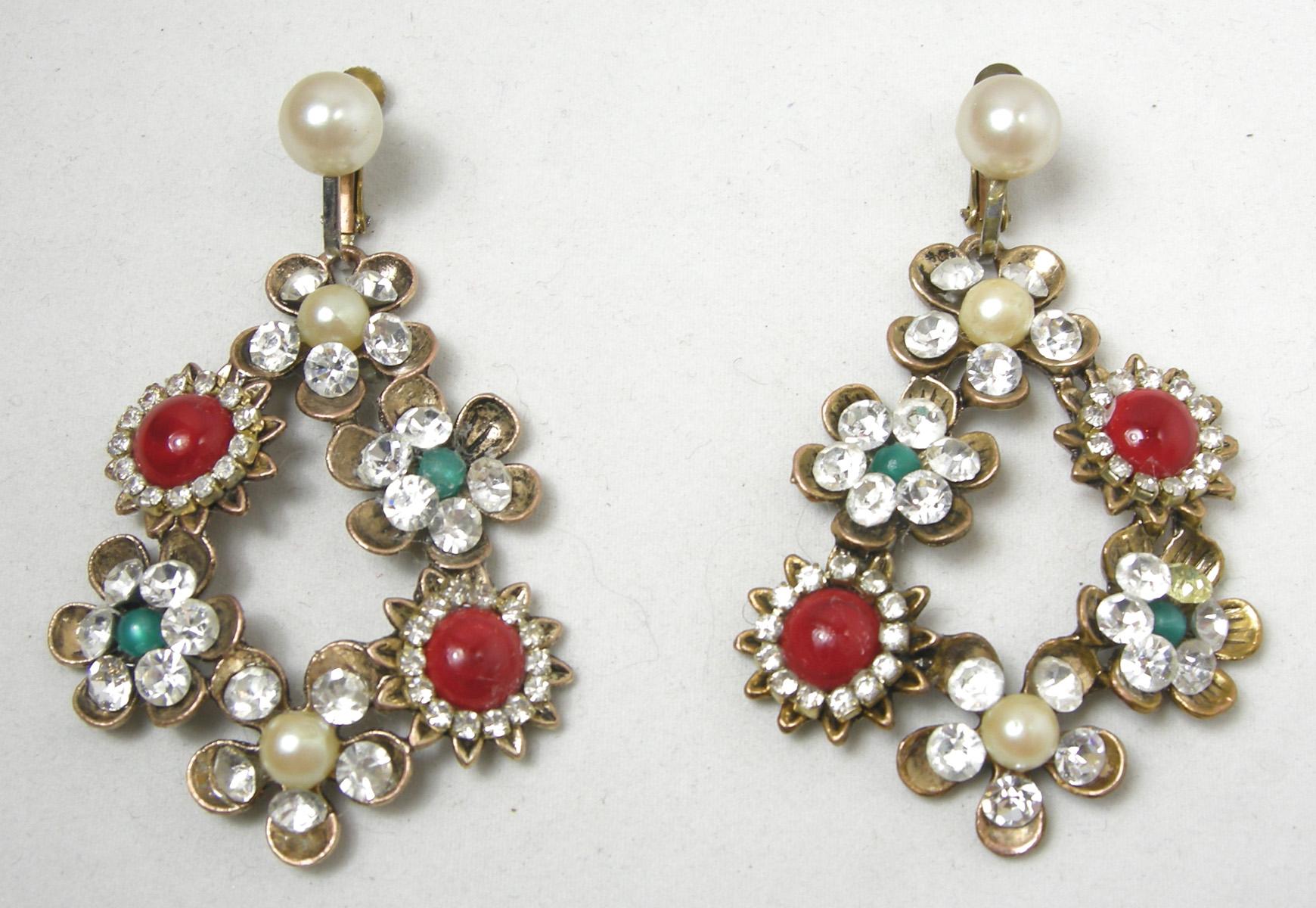 These vintage earrings feature a floral design with faux pearls, clear crystals with red and green bead accents in a gold tone setting.  These clip earrings measure 2-1/2” x 1-5/8 and are in excellent condition.