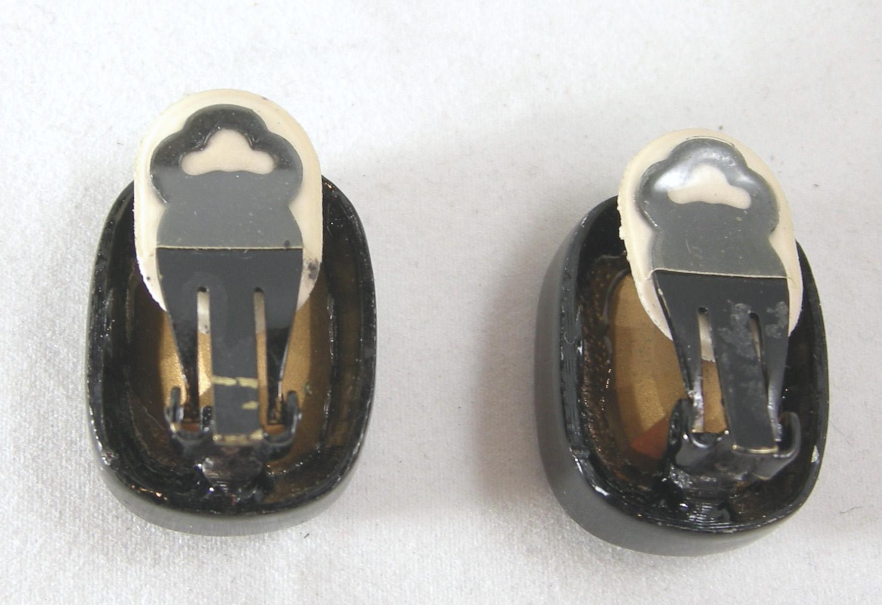 These vintage Kenneth Jay Lane clip earrings are known as “headlight earrings”.  They have a large crystal center set in black enamel.  They measure 1” long x 3/4” wide.  They are signed “Kenneth Lane” and in excellent condition. 