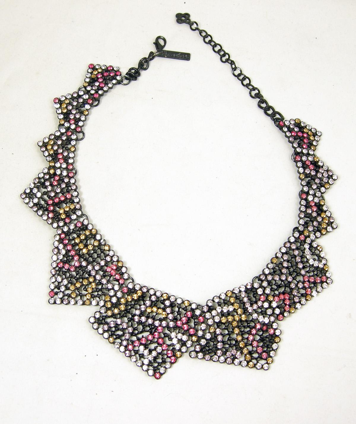 This gorgeous Oscar de la Renta necklace is from the 50s and was one of his runway necklaces.  It has a Japanned metal finish with a geometric design combining beautiful colorful rhinestones of yellow, pink, light purple and clear.  The geometric