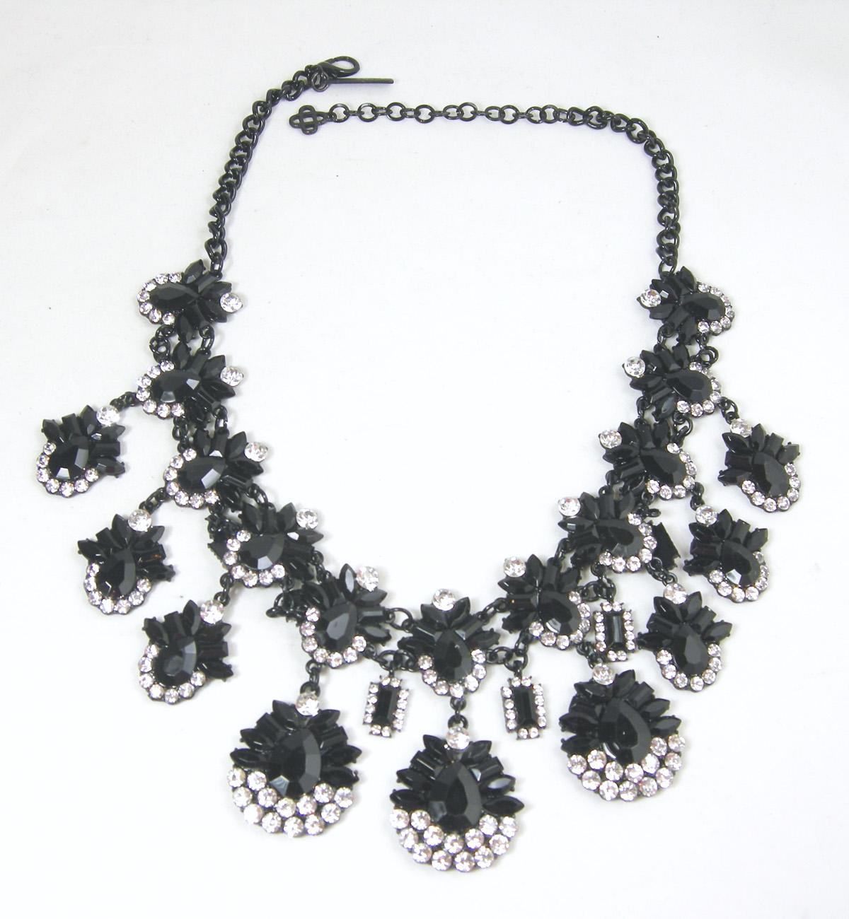 This dramatic Oscar de la Renta Runway necklace is designed with black glass stone teardrops in two rows accented with beautiful rhinestones.  The necklace measures 20” with a lobster clasp in a Japanned metal finish.  The teardrops hang down 3”. 