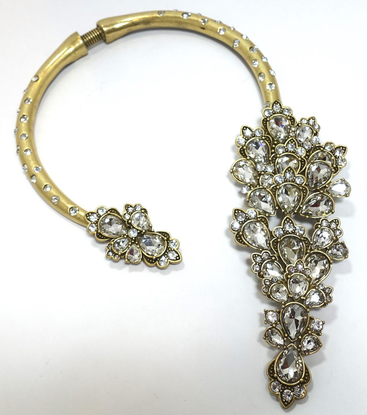 I have bought this Oscar necklace numerous times. It is so feminine with its asymmetric shape that wraps around the neck and has crystals throughout. The stones are made with sparkling crystals. This necklace measures 20” long x 2” at the widest