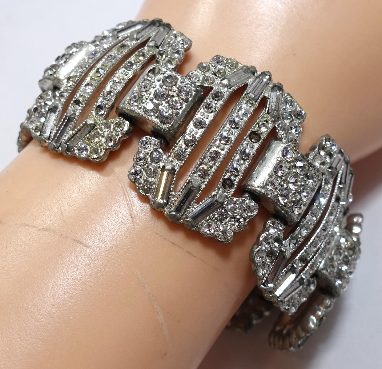 This vintage Art Deco 1930s bracelet features clear rhinestones in the old pot metal setting.  This bracelet measures 7-1/2” x 1-1/8” with a slide in closure and is in excellent condition. All the stones are clear, when photographed to show details,