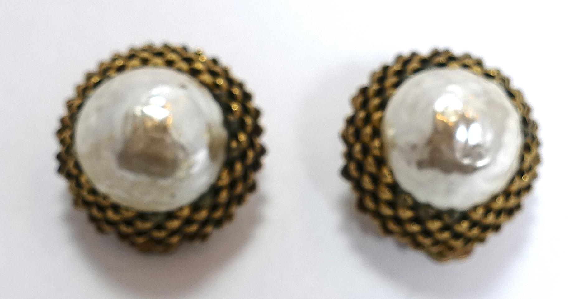 These vintage signed Miriam Haskell earrings feature her famous acorn design.  It has a large baroque faux pearl in a gold tone setting.  These are the large, collectible clip earrings that  measure 1” across and are signed “Miriam Haskell”.  They