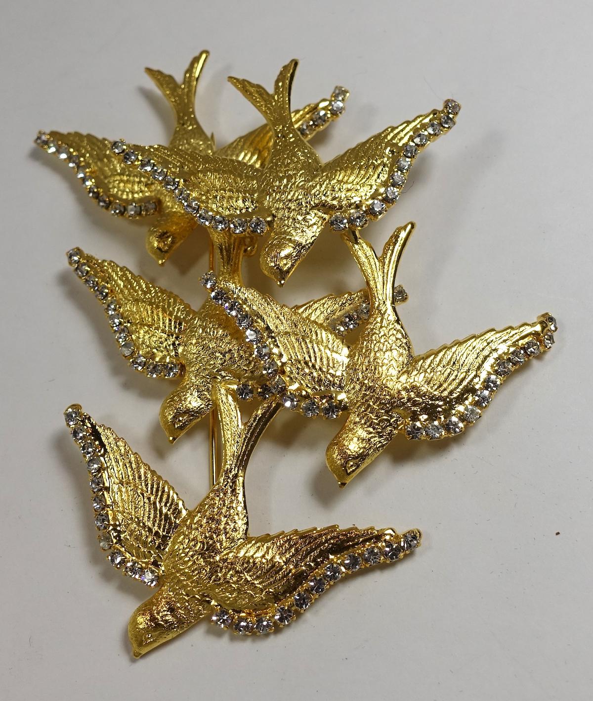 This signed One of a kind Robert Sorrell brooch features the famous ‘birds in flight’ with clear crystal accents in a highly textured gold tone setting.  This brooch measures 4” x 3-1/2” and  is signed “Sorrell Originals”.  It is in excellent