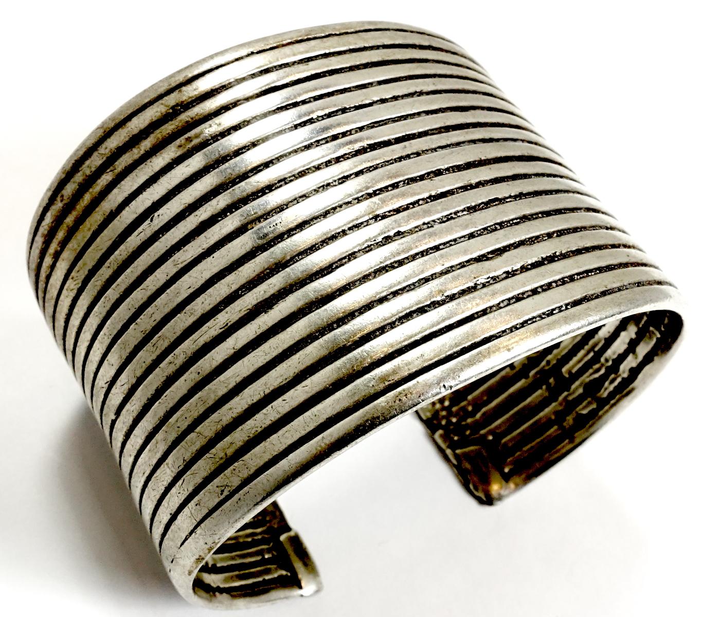 This wide Navajo early Pawn vintage cuff features a heavily carved design in sterling silver.  In excellent condition, this piece measures 7” around the inside x 2” wide.