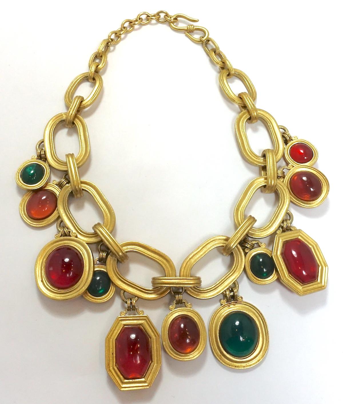 This vintage signed Yves St. Laurent necklace features multi-color drops of poured glass in cranberry, topaz and emerald colors on a large open link gold tone chain.  This necklace measures 18-1/2” long with a hook closure.  The largest drop is