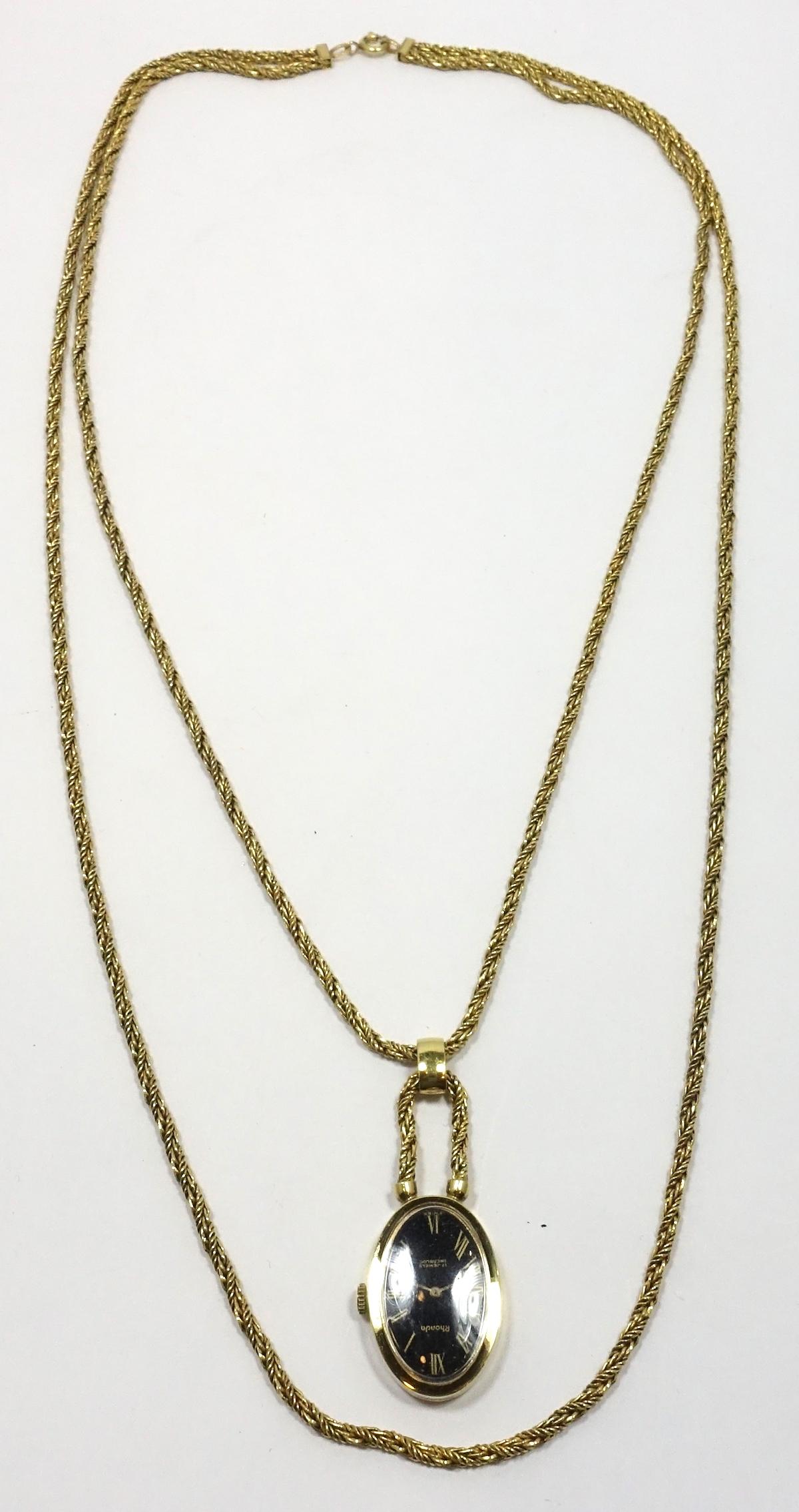 This vintage necklace has two chains with a working 17 Jewel watch pendant hanging from the first chain. It is in a gold tone setting. The inside chain measures 25”; the watch is 1-1/8” x 7/8”.   It is signed “Ronda” and this watch pendant necklace