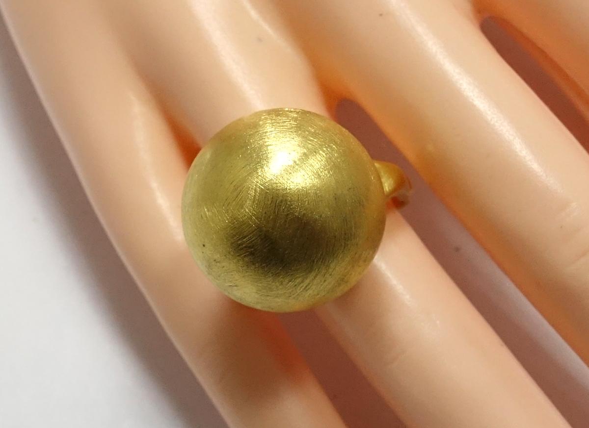 This vintage 1970’s ring features a large ball in a gold-tone setting.  A size 6-1/2, this ring measures ¾” across, is adjustable with a push-in/out ring to a size 7.5 and is in excellent condition.