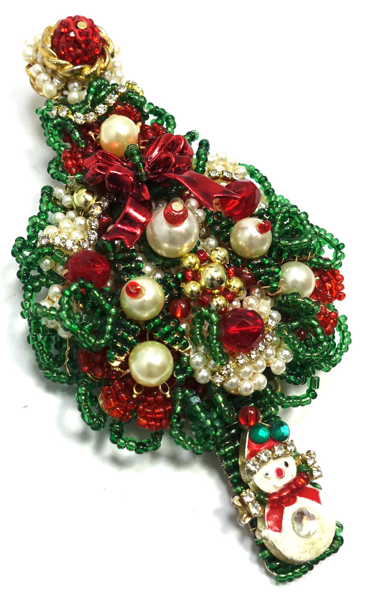 This ANKA brooch features faux pearls with green and red beads and clear crystal accents in a gold-tone setting.  This brooch measures 4-1/2” x 2-1/2”, is signed “ANKA”, and is in excellent condition.