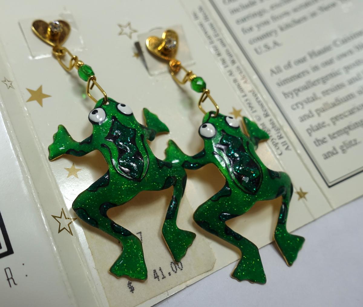 These vintage signed “Lunch at the Ritz” earrings feature a frog design with green, white and black enameling with a heart earpiece and crystal accent on a gold-tone setting.  In excellent condition, these clip earrings measure 3” x 1-1/4”, are