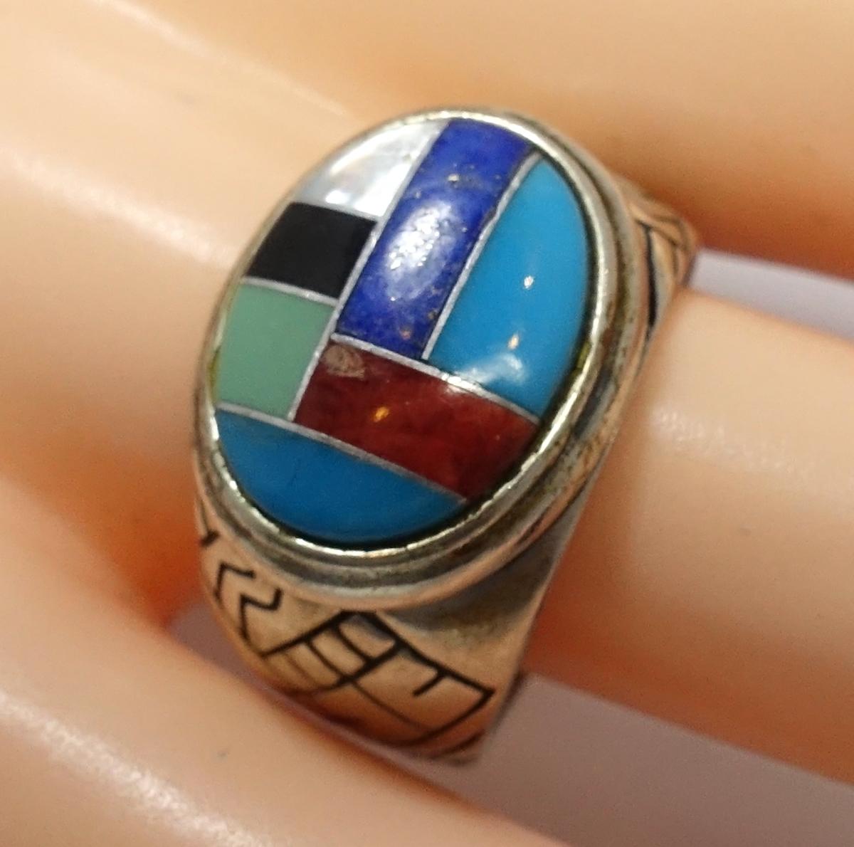 This vintage ring features turquoise, coral, lapis, onyx and mother of pearl in a sterling silver setting.  A size 10.5, this piece measures 5/8” x ½” on the top and is in excellent condition.