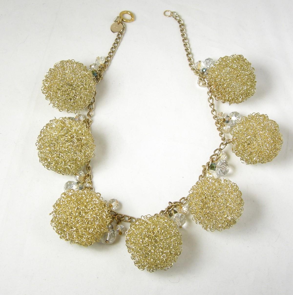 People love this type of necklace … especially when it’s made by Anka. It has 7 gold tone mesh balls with glass beads in-between each ball. It is 17” long with a round push back clasp. Each mesh ball is 5” around. It is signed “Anka” and is in