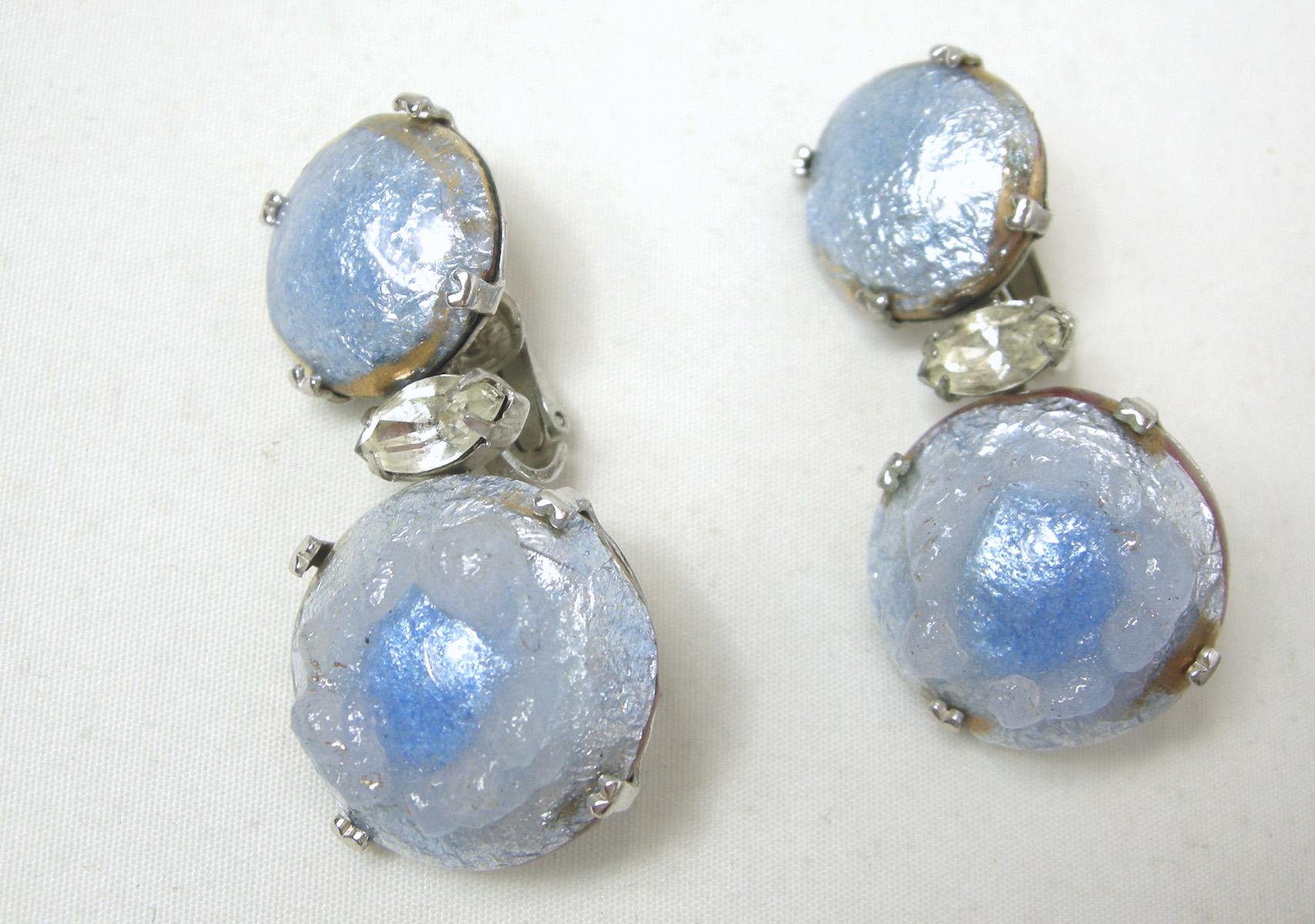 I have never seen such beautiful drop clip earrings.  I first thought they were French because of the blue iridescent stones.  The bottom part has a 3-dimensional floral design in the middle with a drop of blue in the center.  These earrings measure