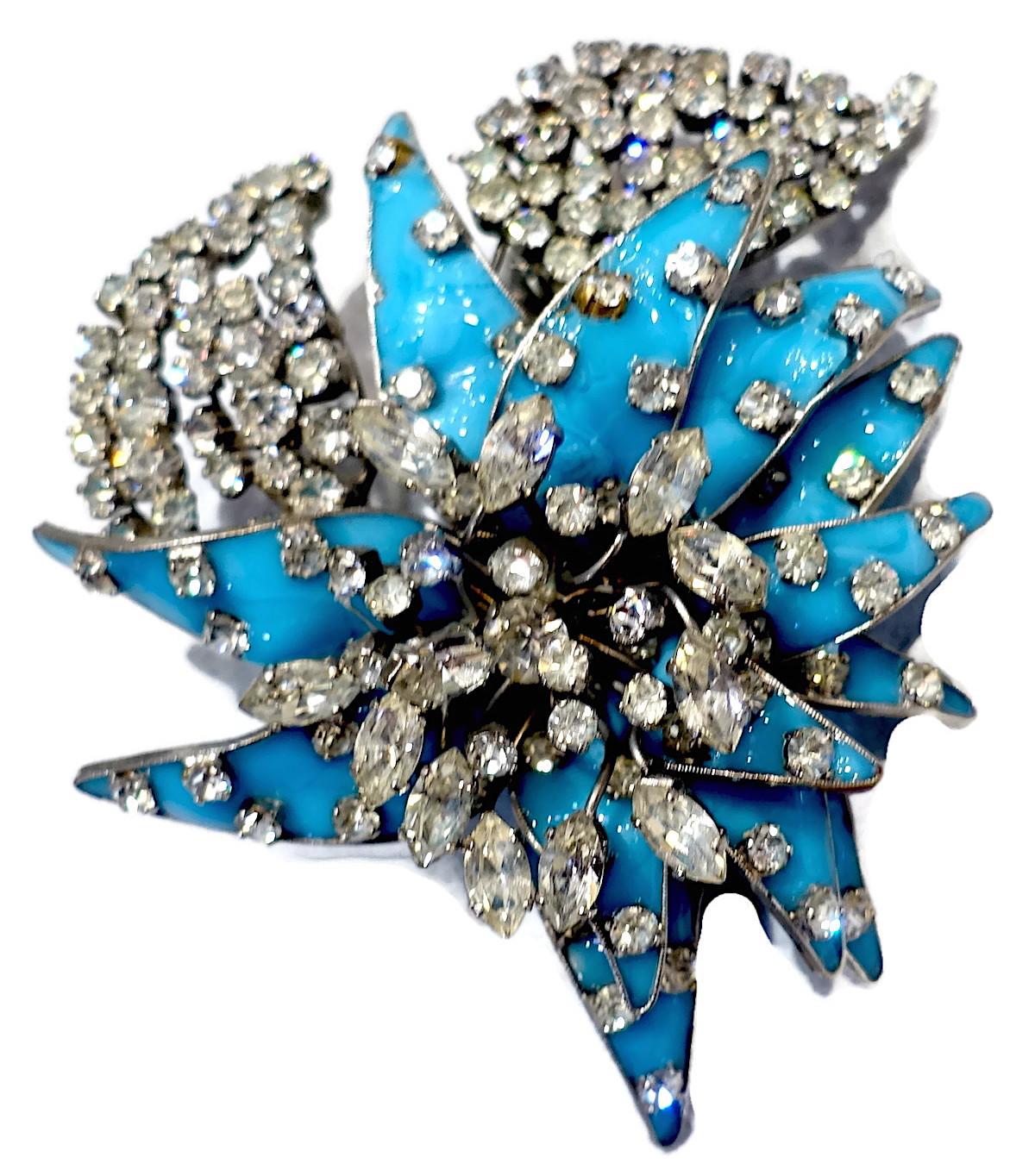 This is an outstanding vintage French fur clip designed in a 3-dimensional floral trembler with turquoise color French glass encrusted with beautiful clear crystals in a silver tone setting.  This fur clip measures 3” x 2-1/2” and is signed