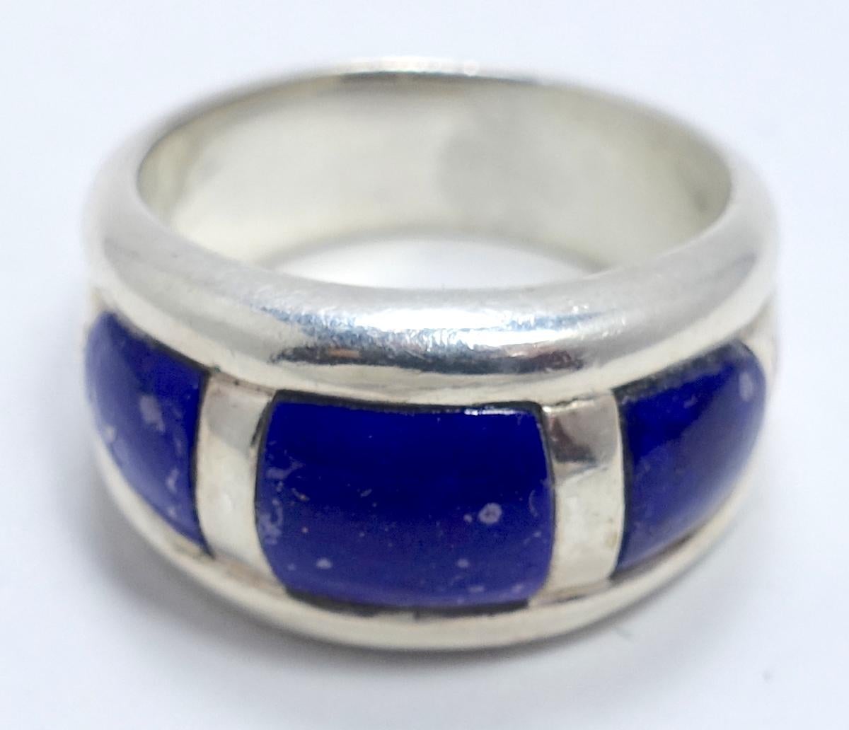 This vintage ring has lapis lazuli stones with sterling silver stripes in a sterling silver setting.  It’s a size 10 and measures 1/2” wide. It is in excellent condition.