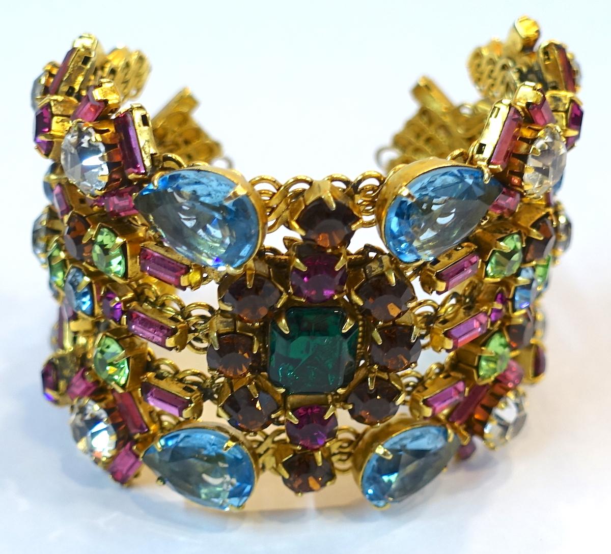 Everyone says this is bracelet has all the attributes of Hobe with multi-color crystals in a gold tone filigree setting.  This bracelet measures 7” around the inside x 2” and is in excellent condition.