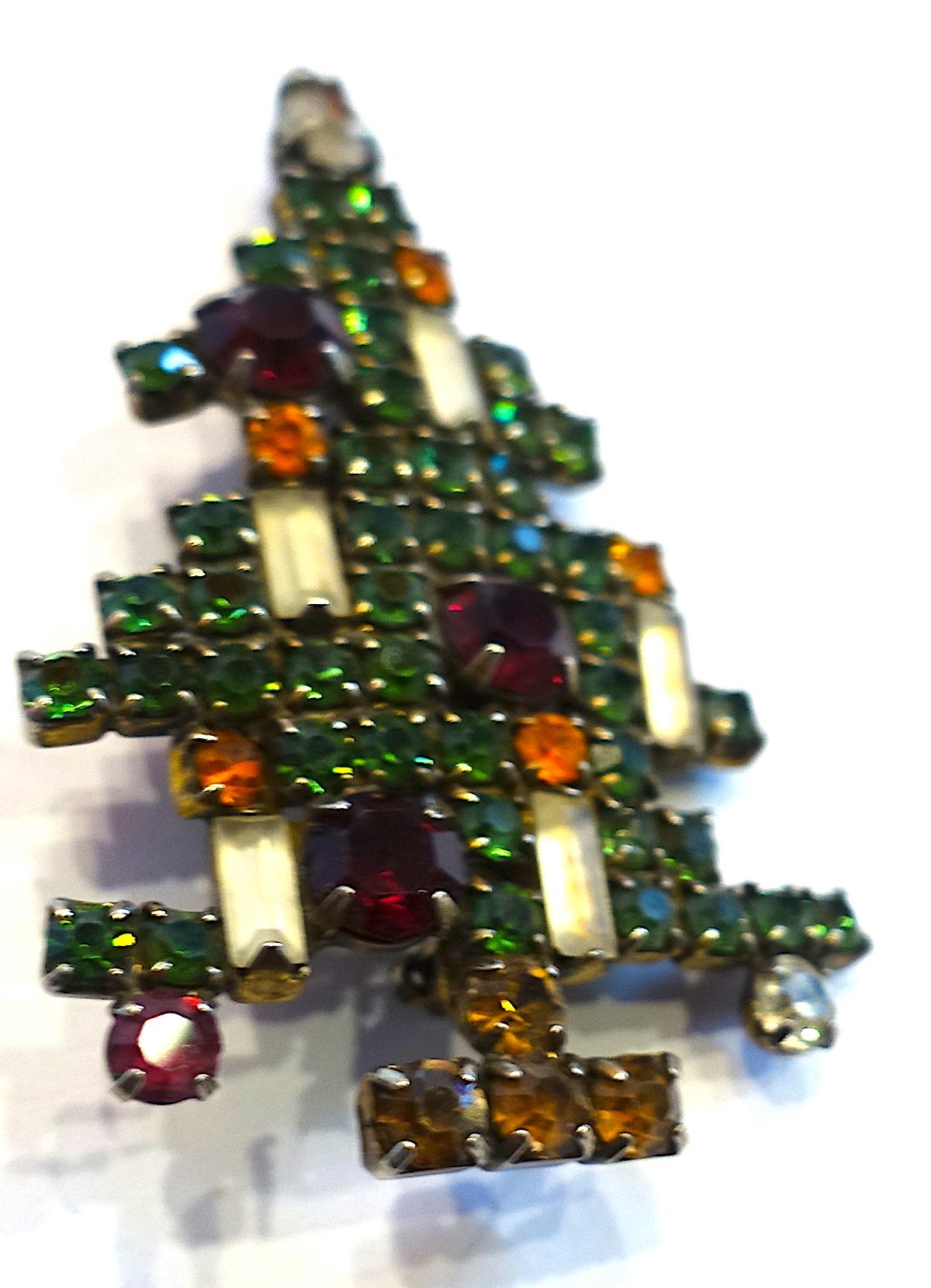 This vintage signed Weiss brooch is the most sought after Christmas tree brooch.  It features a multi-color crystal tree with five candles with in a gold tone setting. In excellent condition, this brooch measures 2” x 1-1/2” and is signed “Weiss”.