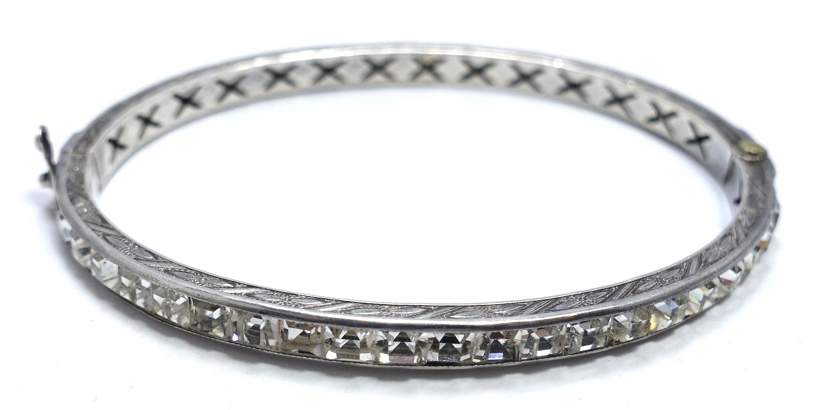 This vintage Art Deco 1930s bracelet features clear crystals in a sterling silver setting.  In excellent condition, this bracelet measures 7” x 3-1/6” with a slide in clasp and safety clip.