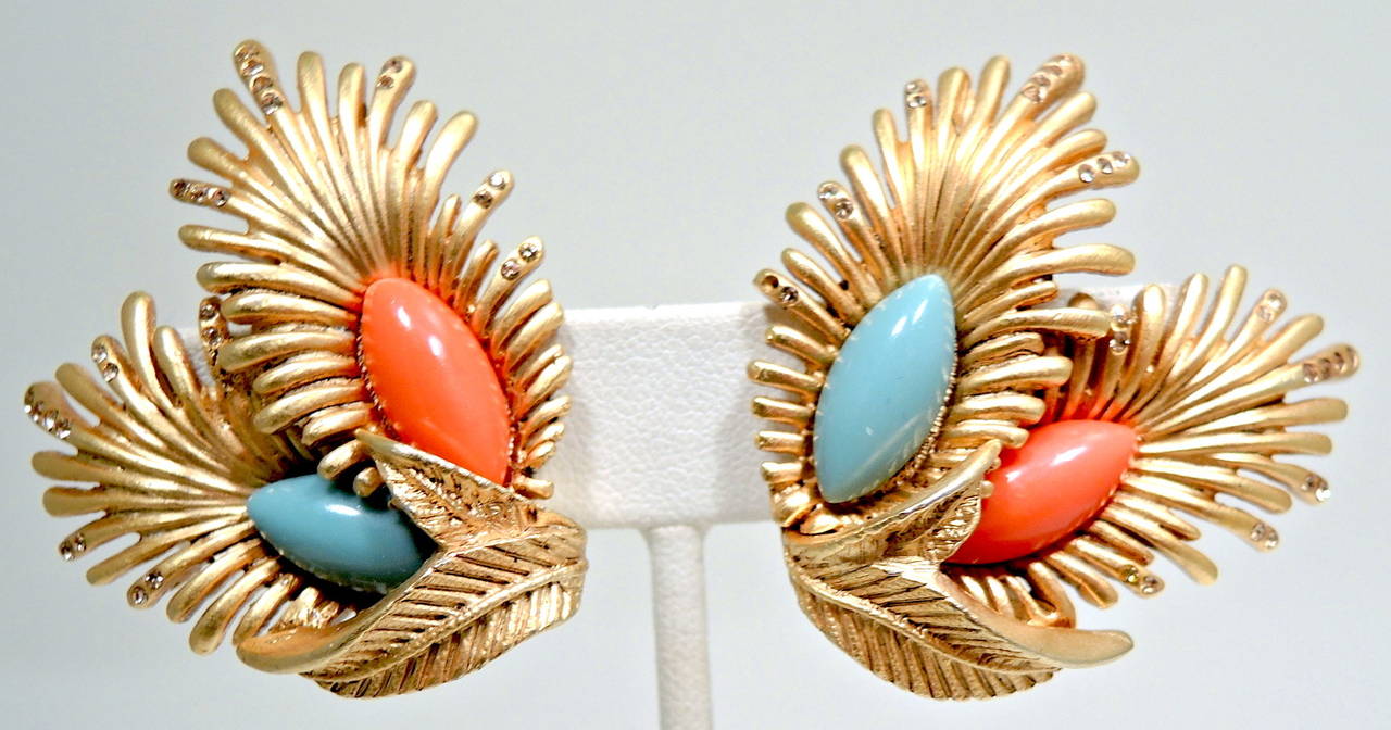 These vintage  Oscar de la Renta earrings feature faux coral and turquoise stones with clear rhinestone accents in a gold-tone setting.  In excellent condition, these clip earrings measure 1 ½” x 1 ½” and are signed “Oscar de la Renta”.