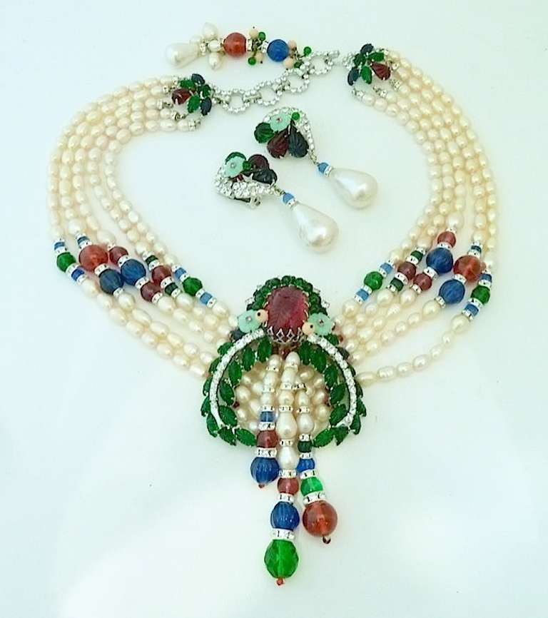 This one of a kind Robert Sorrell necklace features the famous red and green carved glass known as fruit salad, with fresh water pearls and rhinestone accents in a silver-tone setting. The necklace has an inside strand measurement of 18” with a hook