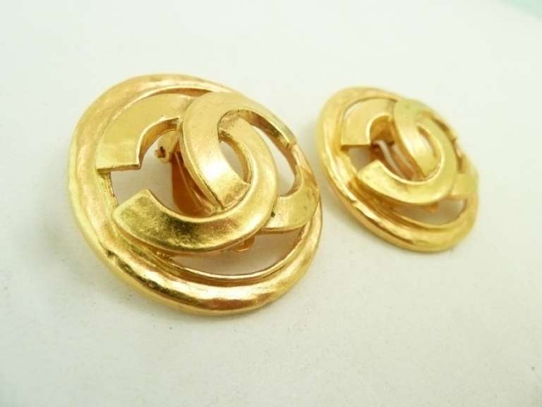 These vintage signed Chanel earrings feature the famous CC logo in a gold-tone setting.   In excellent condition, these clip earrings measure 1 3/8” in diameter and are signed Chanel 94P Made in France.