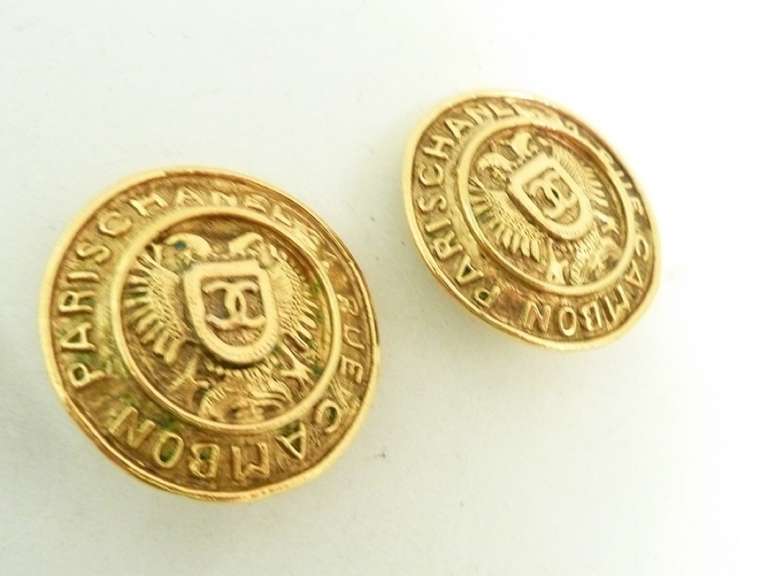 These vintage  Chanel earrings feature the famous CC logo in the center with the Chanel Rue Cambon address encircling the rim, all in a gold-tone setting.   In excellent condition, these clip earrings measure 1 1/4” in diameter and are signed Chanel