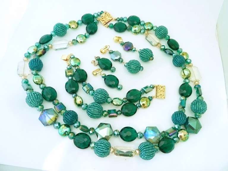 This fabulous one of a kind set by R. E. Roselli features turquoise and clear tone beads in a gold-tone setting.  The two-strand necklace measures 27” with a pressure closure and the largest bead is 7/8” in diameter; the bracelet is 8” with a