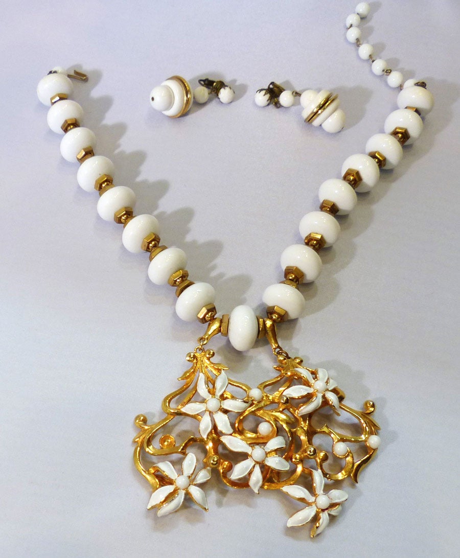 This is one of my favorite Lucien Piccard necklaces. It is very feminine and gets a very strong reaction from people when you wear it. . This set features white color resin beads with white enamel accents on a gold-tone setting. The pendant measures