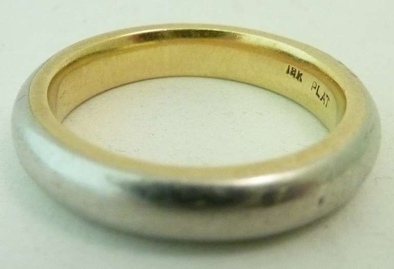 This is a heavy, rare wedding band. It is a vintage ring that features 18kt gold inside the ring as a lining, and platinum on the outside. In excellent condition, this ring is a size 11, measures 1/8” wide and is signed Plat 18kt.