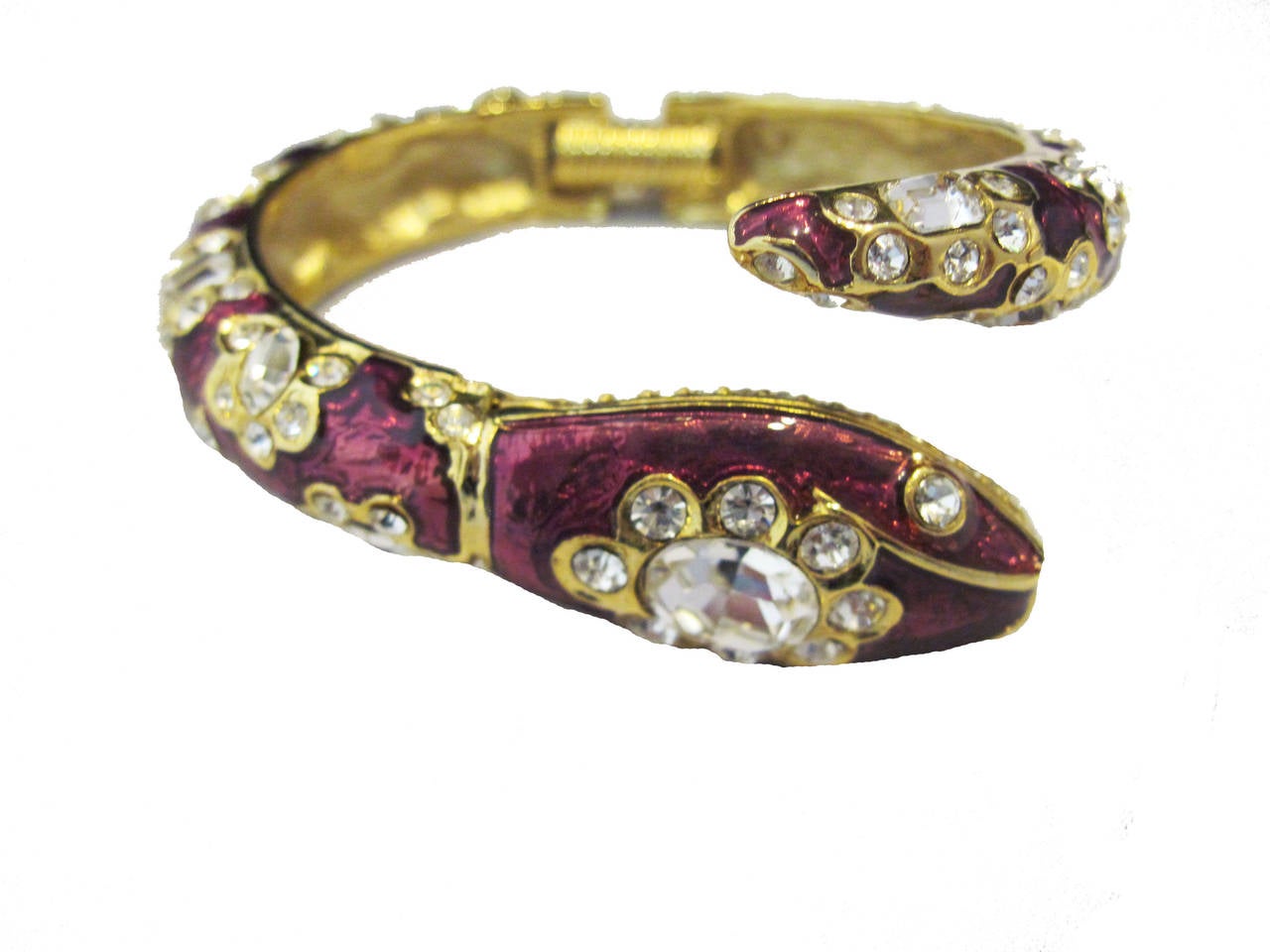 This is not a fierce snake bracelet. In fact, its colors clearly let you know it’s a beautiful snake bracelet with amethyst purple enameling features clear rhinestone stones that come in different shapes and sizes. Signed Kenneth Lane, this bracelet