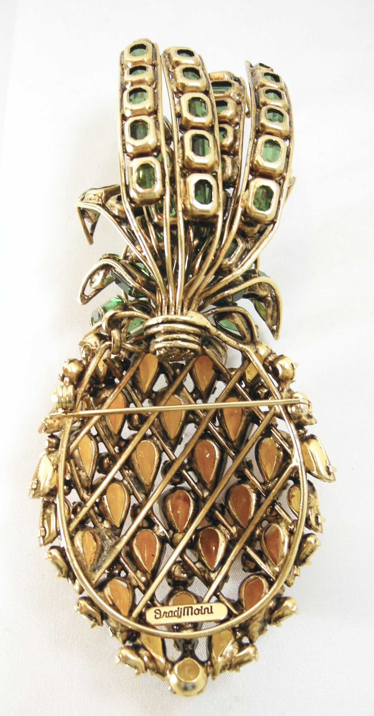 I remember when I first saw this pin during the 1980s.  It was a definite showstopper.  This vintage large beautiful pineapple pin features prong set topaz colored cabochon teardrops, round clear faceted crystals and green emerald cut stones on a