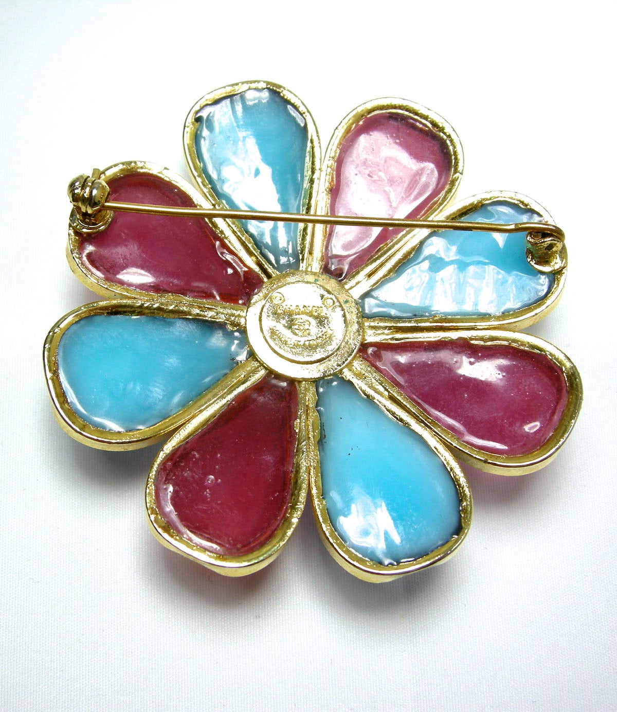 I love these vintage Chanel Gripoix pins.  They are so hard to find and this one is a true beauty.  It ha a floral design with turquoise and pink Gripoix petals encrusted with gold tone metal.  There is a square shaped yellow Gripoix glass in the