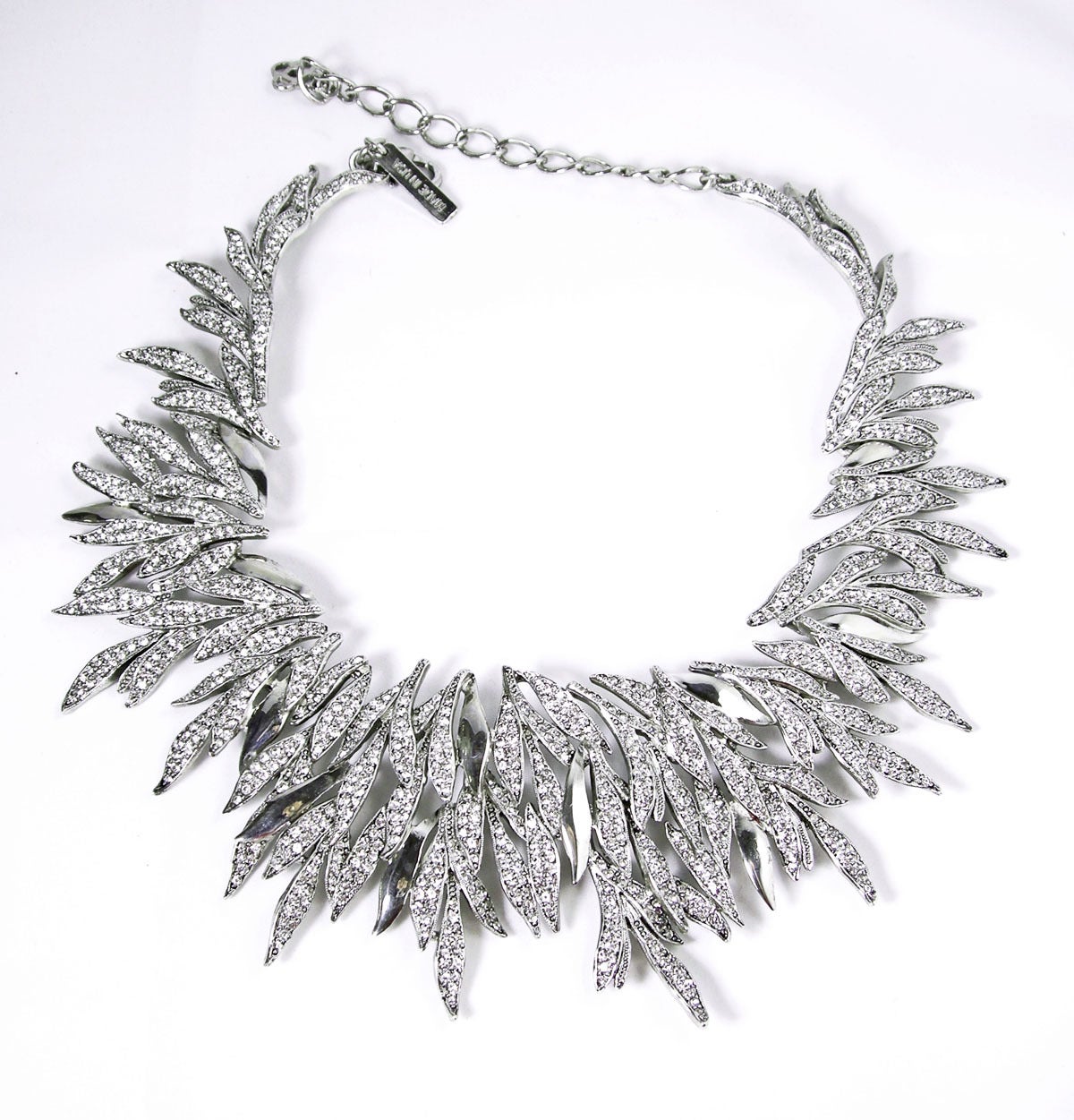 Ethereal and elegant this statement necklace features an intricate motif of cascading Austrian crystals leaves in a silver plated setting. It is simply dazzling with its fabulous pave crystal leaves. The necklace is very flexible and is signed