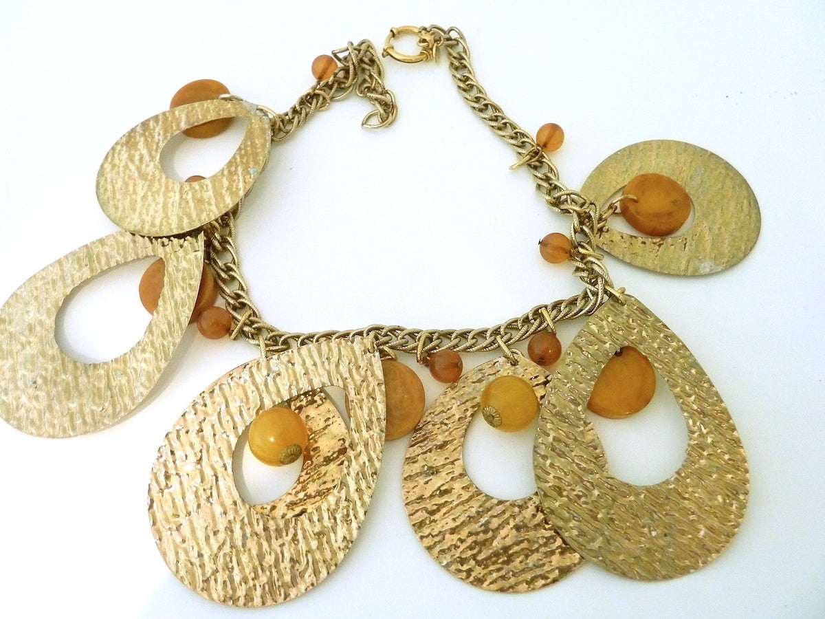 This vintage Anka necklace features various shaped Bakelite beads in a mottled gold-tone setting.  This necklace measures 18” long with a spring closure. Each tear drop is 2-3/8” x 2”.  It’s in excellent condition and signed “Anka.”