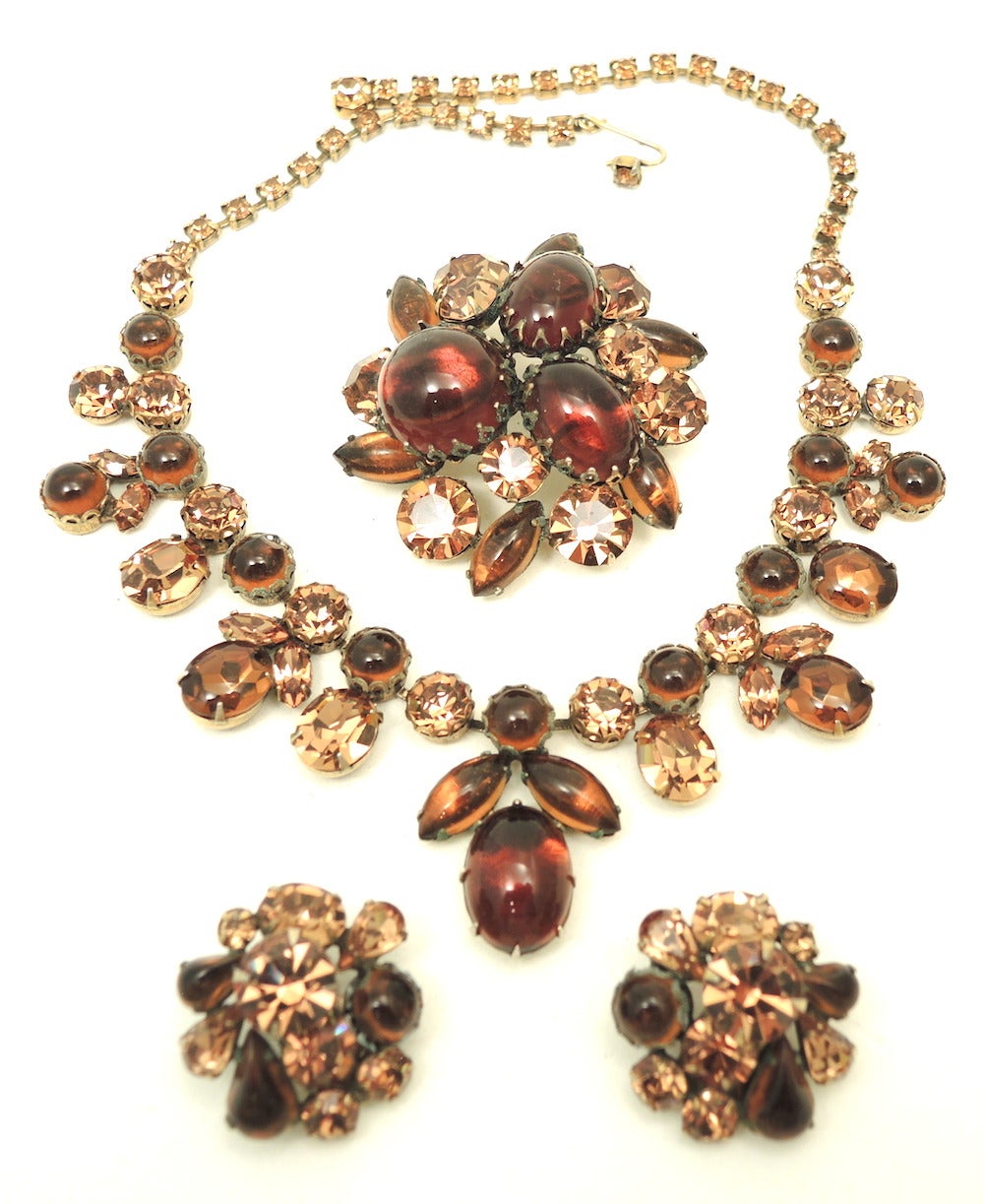 This parure, is beautifully made and has a very expensive to it.  It is a vintage unsigned Schreiner set that features topaz color rhinestones in a gold-tone setting.  The necklace measures 16” with a hook closure with a front drop of 1 ¼” top to