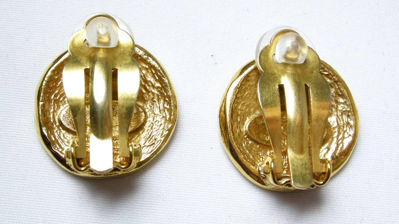 These Chanel earrings have Chanel 31 Rue Cambon address on the front on a gold-tone metal setting.  They are signed  “Chanel Made in France” and measure 1-1/3” X 1-1/3”.  These earrings are in excellent condition.
