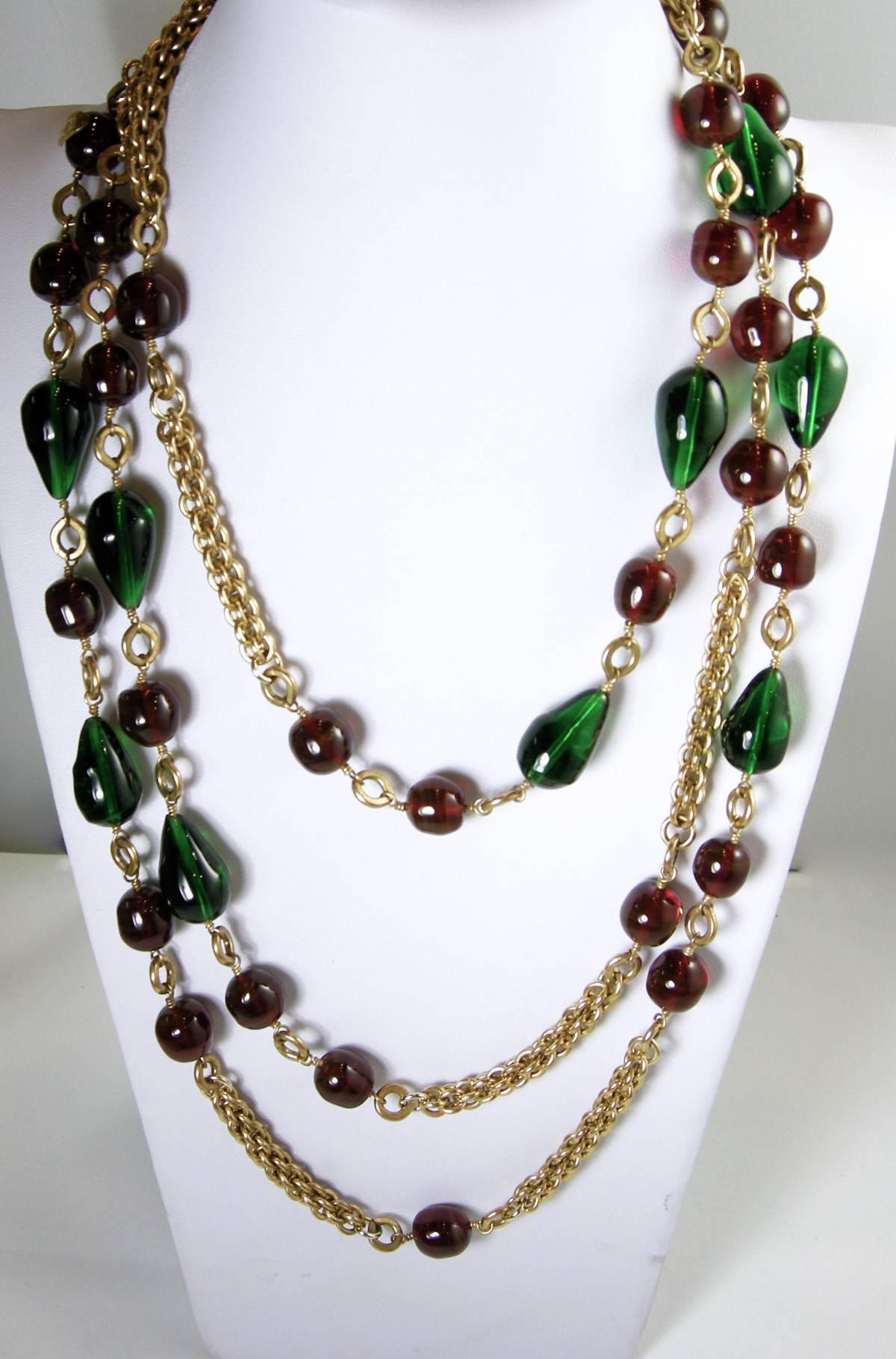 Wow, this is just a stunning Chanel necklace with cranberry and emerald color Gripoix glass in a gold-tone setting. This Gripoix glass necklace measures 71” x 1/2” with a spring closure and is signed “Chanel Made in France” and “23, which means
