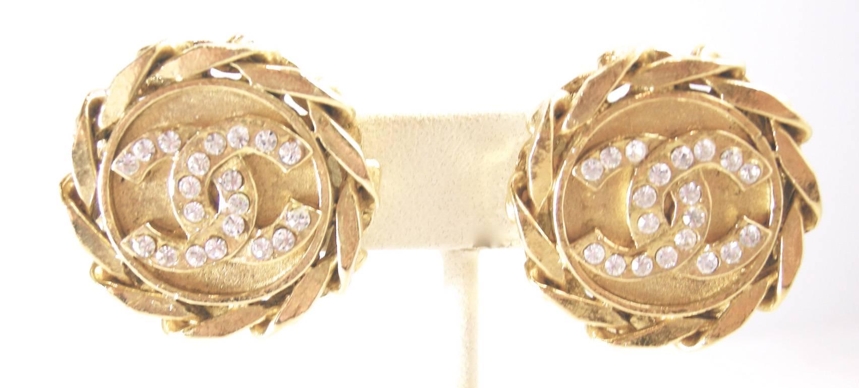 These vintage signed Chanel earrings feature the famous CC logo with clear rhinestone in a gold-tone setting.  These clip earrings measure 1-1/4” in diameter and are signed “Chanel 23 Made in France” and are in excellent condition.