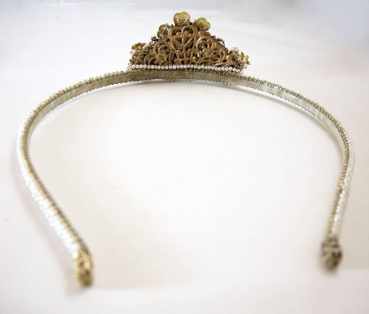 It’s always a surprise when you find something so rare in such fabulous condition!  This art deco Miriam Haskell headband-tiara features faux pearls with clear rhinestone accents in a gold-tone setting.  This headband/tiara measures 15-1/2” x 1/4”