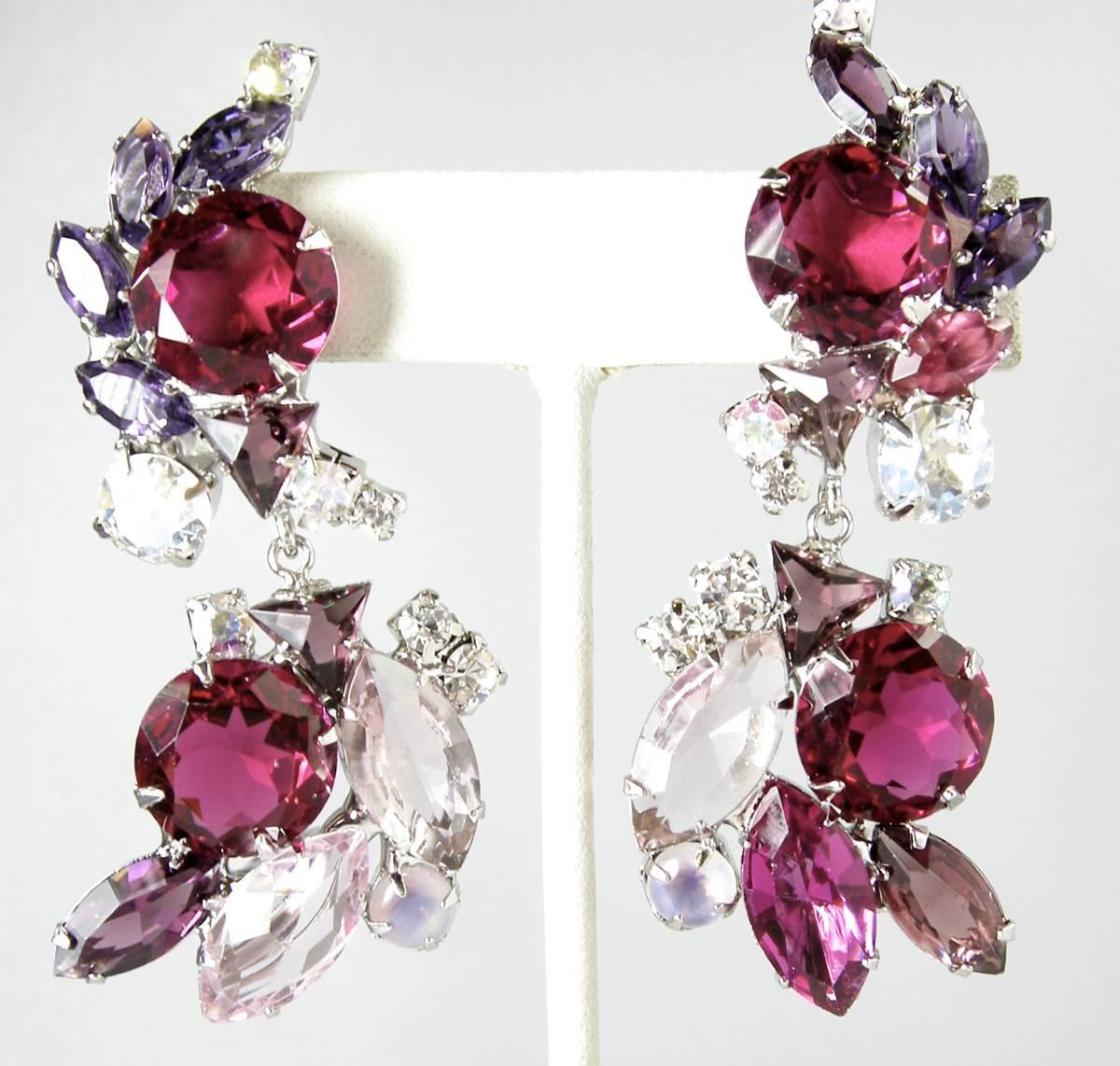 These one of a kind earrings by Robert Sorrell feature rich red and clear faceted crystals in a silver-tone setting. These clip earrings measure 3-1/2” x 1-1/8” and are signed “Sorrell Originals”. These are earrings are in excellent condition.