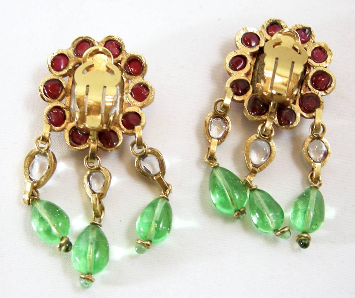 If you’re a collector of Gripoix, then you have to love and appreciate these vintage clip Gripoix dangling earrings. These earrings are designed with green, red and clear poured gripoix glass nestled in the classic vintage chanel style that we no