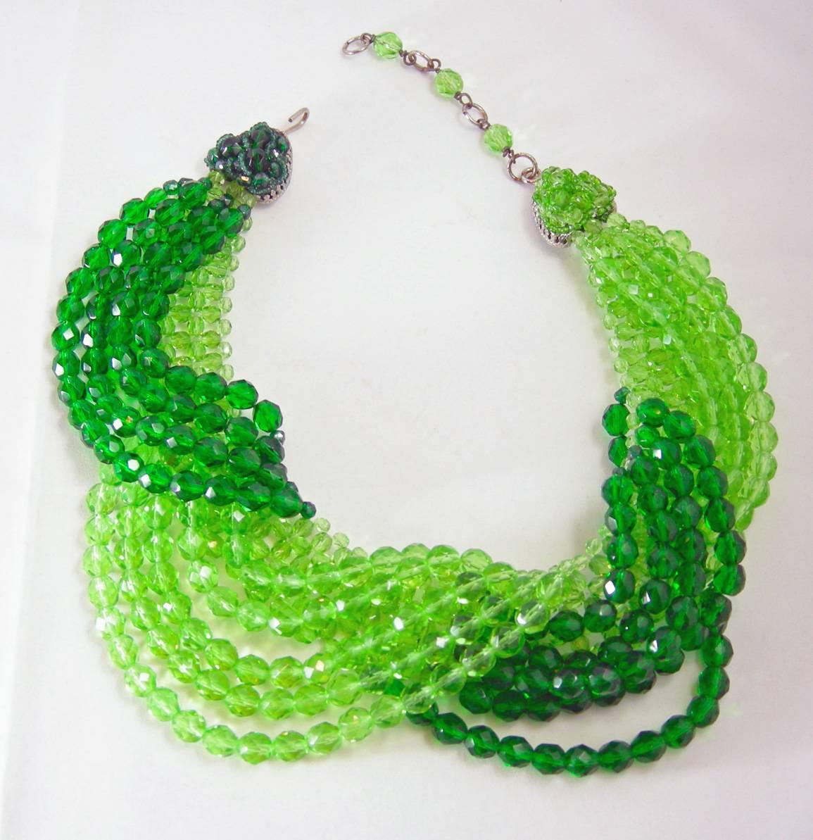 This gorgeous Coppola e Toppo Italy necklace features bevel cut light & dark green glass beads in a gold-tone setting.  This necklace measures 16 1/2” with a hook closure with the widest drop being 3” top to bottom.  In excellent condition, this