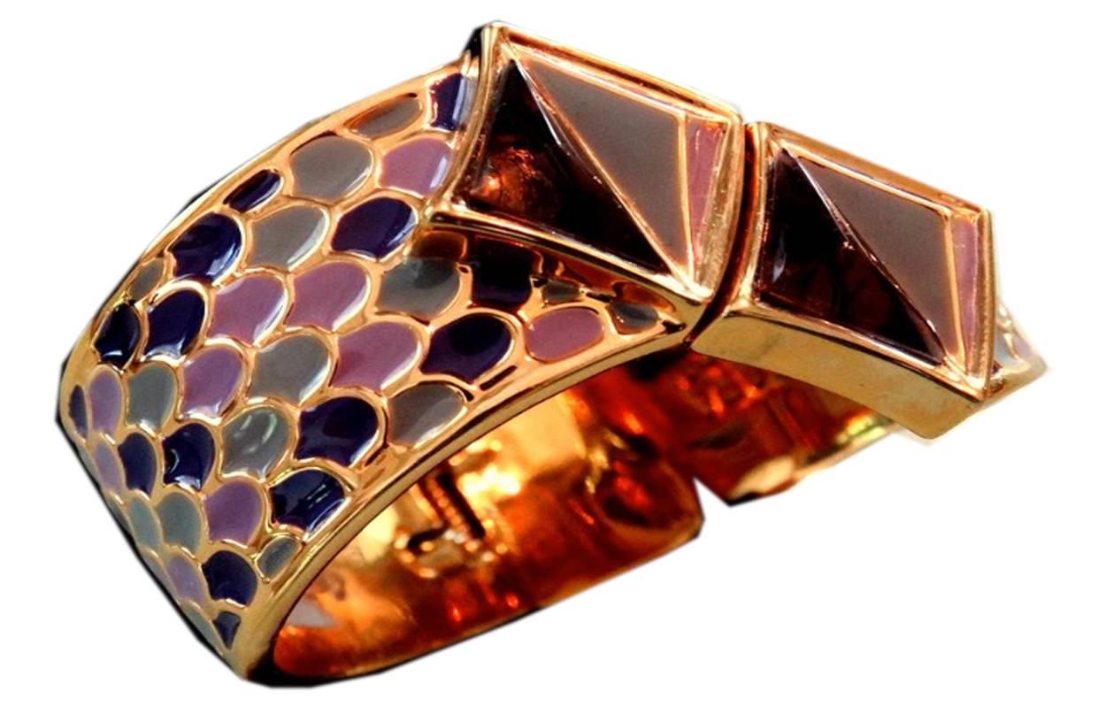 This bracelet came from a very high-end estate.   It is very dramatic and definitely a statement piece.  The front has triangles with Gripoix glass and tri-color enameling.  The cuff has spectacular shades of blue and violet enamel set in 22 karat