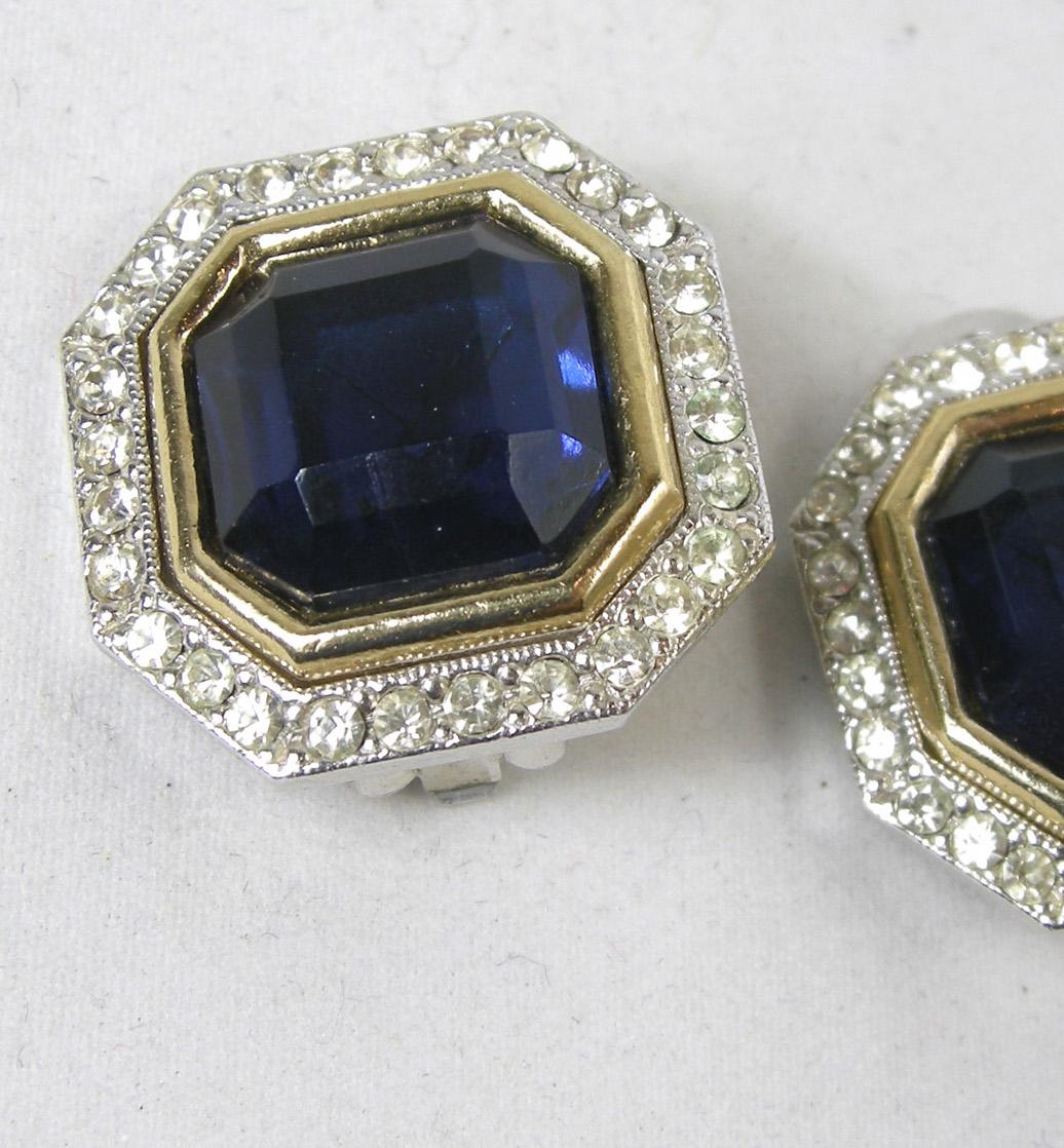 These extremely well made clip earrings that have glistening rhinestones surrounding the royal blue faux sapphire hexagon shaped earrings.  They measure 1” x 1”.  I think they were part of a designer set, but often the earrings were not signed. 