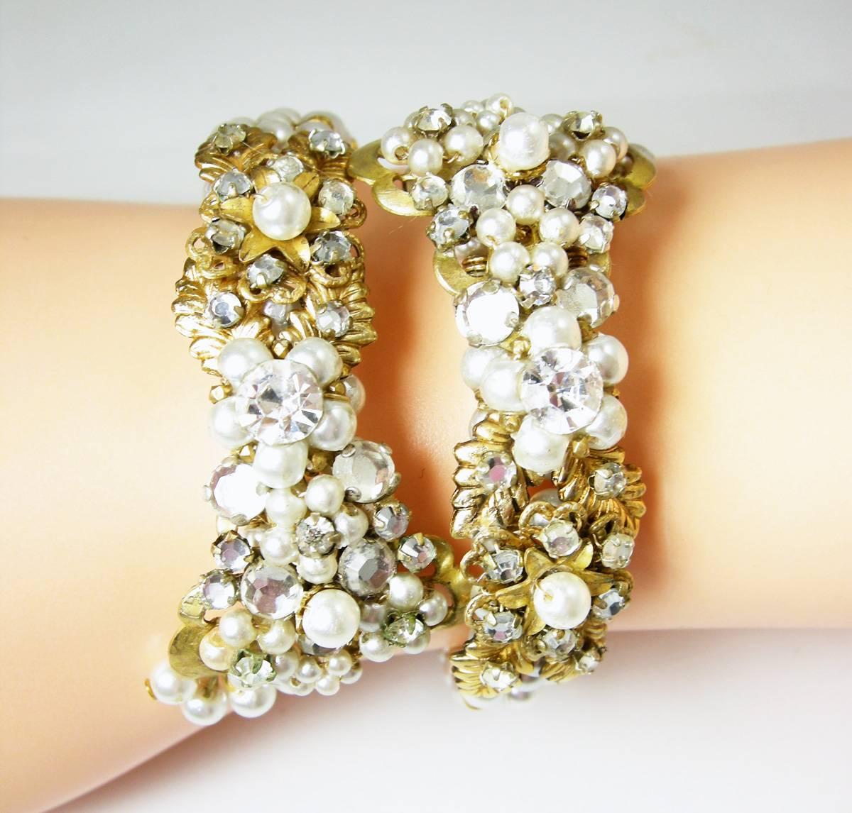 This authentic all original vintage Miriam Haskell flexible spring clamper features faux pearls with clear rhinestone accents, gold-tone leaves and setting. The bracelet is 1/2” wide and will fit a size 5-7 wrist. It’s in excellent condition.