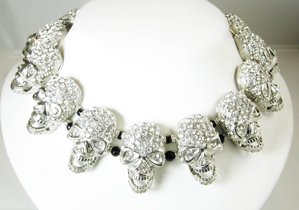 Robert Sorrell found these skulls and, of course, he had the brilliant idea to make a skull necklace.  It looks absolutely beautiful on.  It has 18 rhinestone skulls in a silver tone setting.  This necklace measures 15-1/2” long and 1” wide and has