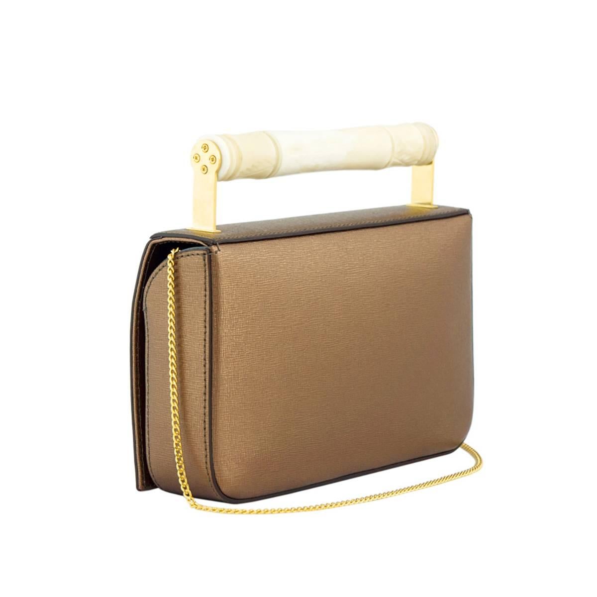 Hand carved camel bone handle

Bronze saffiano finish leather with grey pigskin lining

Brass hardware

Magnetic flap closures

Long chain shoulder strap

Internal card holder and zip pocket