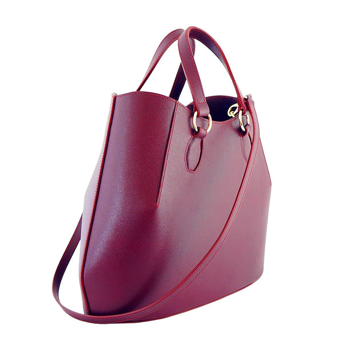 Burgundy saffiano finish calf leather with black pigskin lining

Brass hardware

Detachable long shoulder strap

Internal phone holders, open pocket and two zip pockets